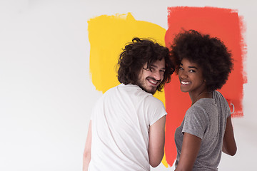 Image showing multiethnic couple painting interior wall