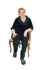 Image showing Senior woman relaxing in armchair.