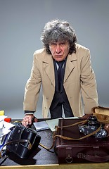 Image showing The senior man as detective or boss of mafia on gray studio background