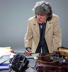 Image showing The senior man as detective or boss of mafia on gray studio background