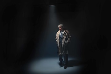 Image showing The senior man as detective or boss of mafia on gray studio background