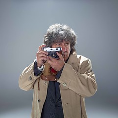 Image showing The senior man as detective or boss of mafia on gray studio background