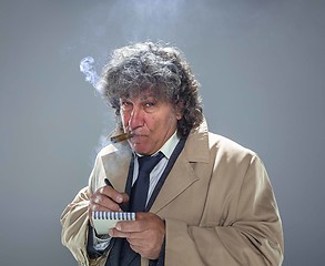 Image showing The senior man as detective or boss of mafia on gray studio background