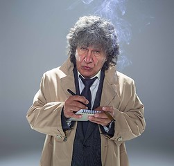 Image showing The senior man as detective or boss of mafia on gray studio background