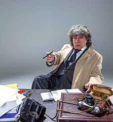 Image showing The senior man as detective or boss of mafia on gray studio background