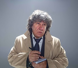 Image showing The senior man as detective or boss of mafia on gray studio background