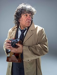 Image showing The senior man as detective or boss of mafia on gray studio background