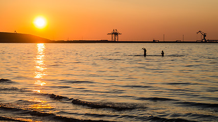 Image showing Couple bathing at sunset in the sea