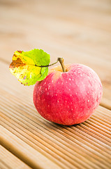 Image showing Ripe red apple with a leaf, close-up