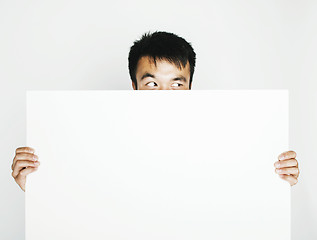 Image showing pretty cool asian man holding empty white plate smiling