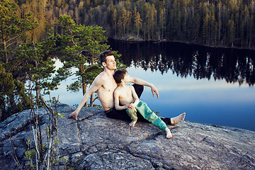 Image showing middle age man with little cute son doing sport yoga on the top of the mountain together, happy family lifestyle people outdoor, summer wild nature for training