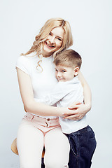 Image showing young modern blond curly mother with cute son together happy smiling family posing cheerful on white background, lifestyle people concept, sister and brother friends