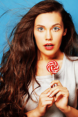 Image showing young pretty adorable woman with candy close up like doll