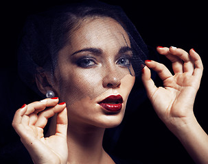 Image showing beauty brunette woman under black veil with red manicure close u