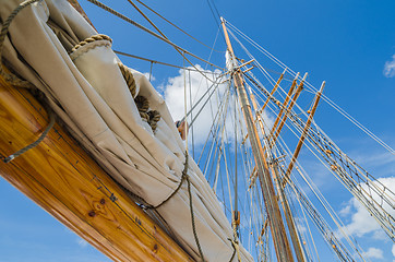 Image showing Folded sail and mast on an old sailboat