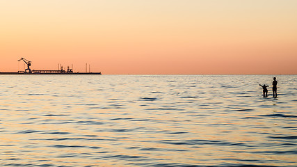 Image showing Couple bathing at sunset in the sea