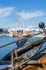 Image showing Old rusty anchor at a board of the old sailboat 