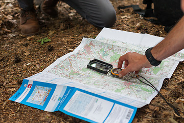 Image showing Navigating with map and compass