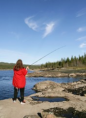 Image showing Woman fishing by a lake