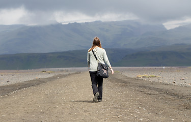 Image showing Woman hiker walking in mountain landscape