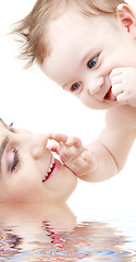 Image showing happy blue-eyed baby boy touching mama