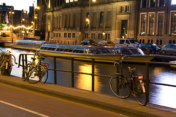 Image showing boats on the canal with bicycles night amsterdam holland