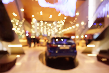 Image showing Blurred, defocused background of public event exhibition hall showing cars and automobiles