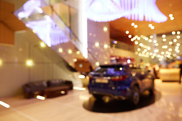 Image showing Blurred, defocused background of public event exhibition hall showing cars and automobiles