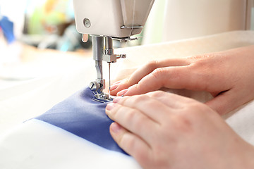 Image showing Woman sewing on the sewing machine