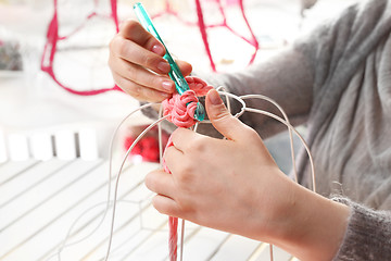 Image showing Needlework. Handicraft. Knitting crochet. The woman knits crochet.