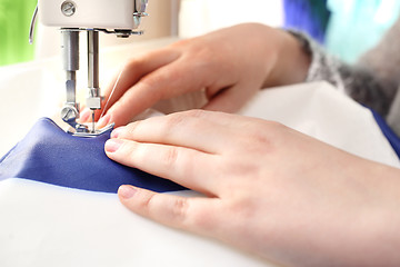 Image showing Sewing on a machine.
