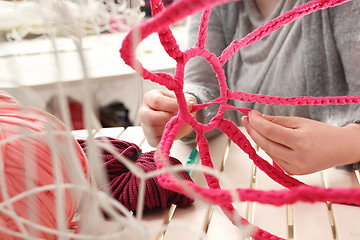 Image showing Knitting crochet. The woman knits crochet.