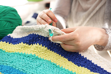 Image showing Handicraft. Knitting crochet. The woman knits crochet.