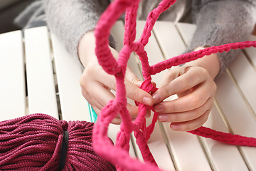 Image showing Knitting crochet. The woman knits crochet.