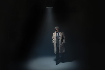 Image showing The senior man as detective or boss of mafia on gray studio background