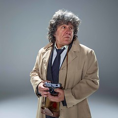 Image showing The senior man as detective or boss of mafia on gray studio background