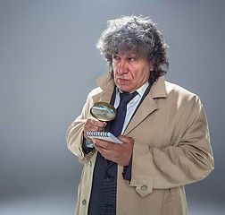 Image showing The senior man as detective or boss of mafia on gray studio background