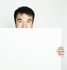 Image showing pretty cool asian man holding empty white plate smiling