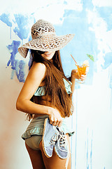 Image showing cute bright woman in sunglasses and hat with cocktail in bikini 