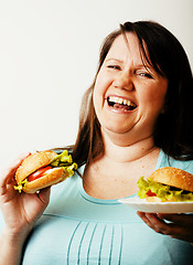 Image showing fat white woman having choice between hamburger and salad close 