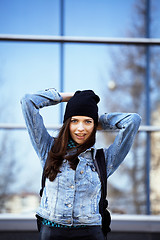 Image showing young pretty girl near business building walking