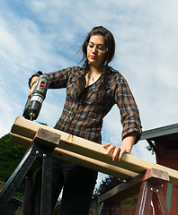 Image showing Craftsperson Woman Uses Power Screwdriver Drilling Holes Wood