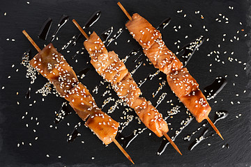 Image showing fish kebabs. on a black slate plate.