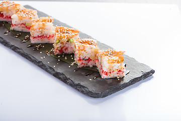 Image showing set of sushi on a slate square plate. 