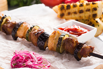Image showing shish kebab on skewers with onions and vegetables. 