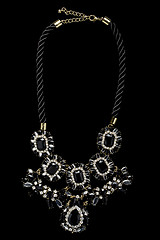 Image showing necklace on a black background. gems. 