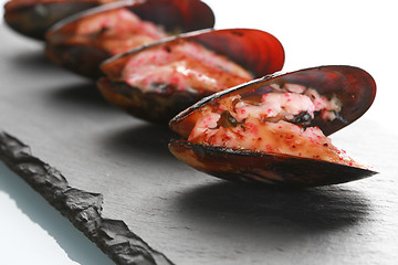 Image showing mussels in their shell on a black slate plate