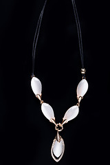 Image showing necklace on a black background. gems. 