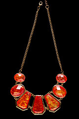 Image showing red necklace on a black background. gems. 