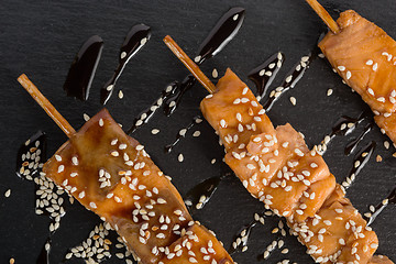 Image showing fish kebabs. on a black slate plate.